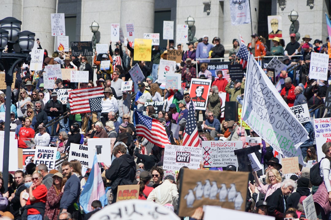 A crowd of protesters hold signs in a demonstration.