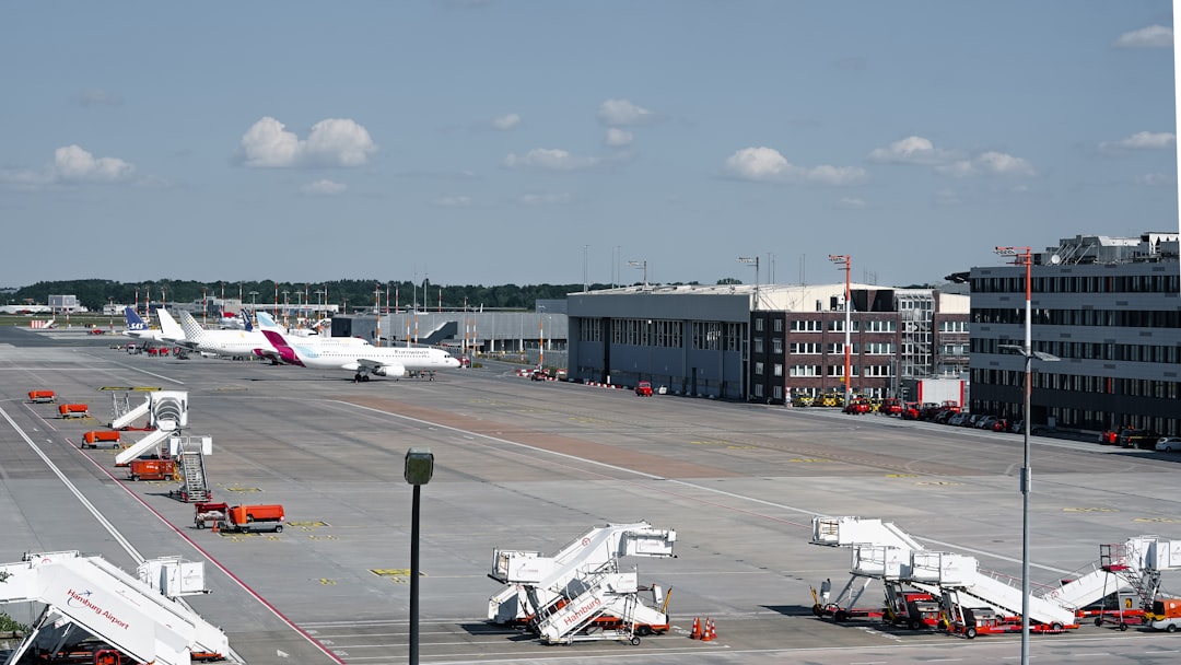 Airplanes and stairs are on the airport tarmac.