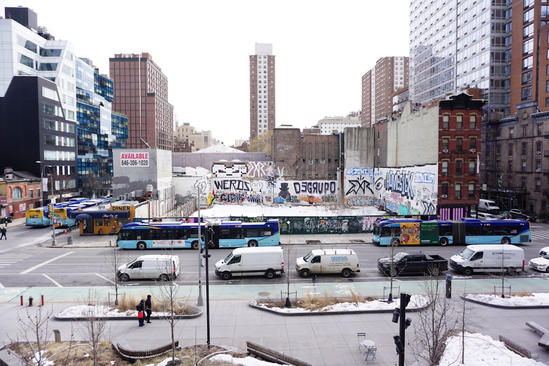 City street with buses, vans, and buildings