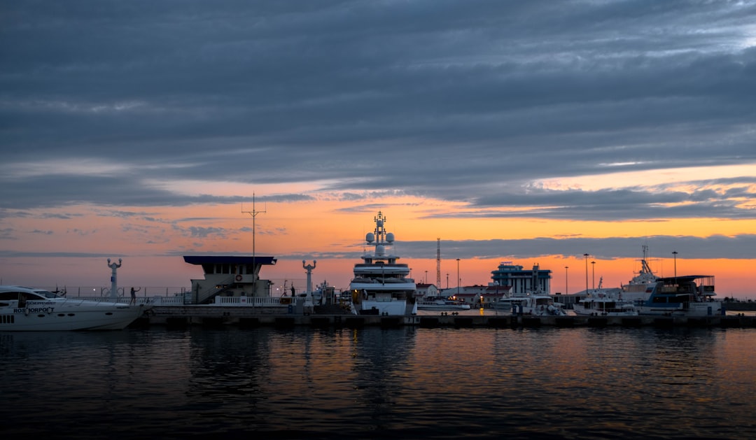 white and black ship on sea during sunset