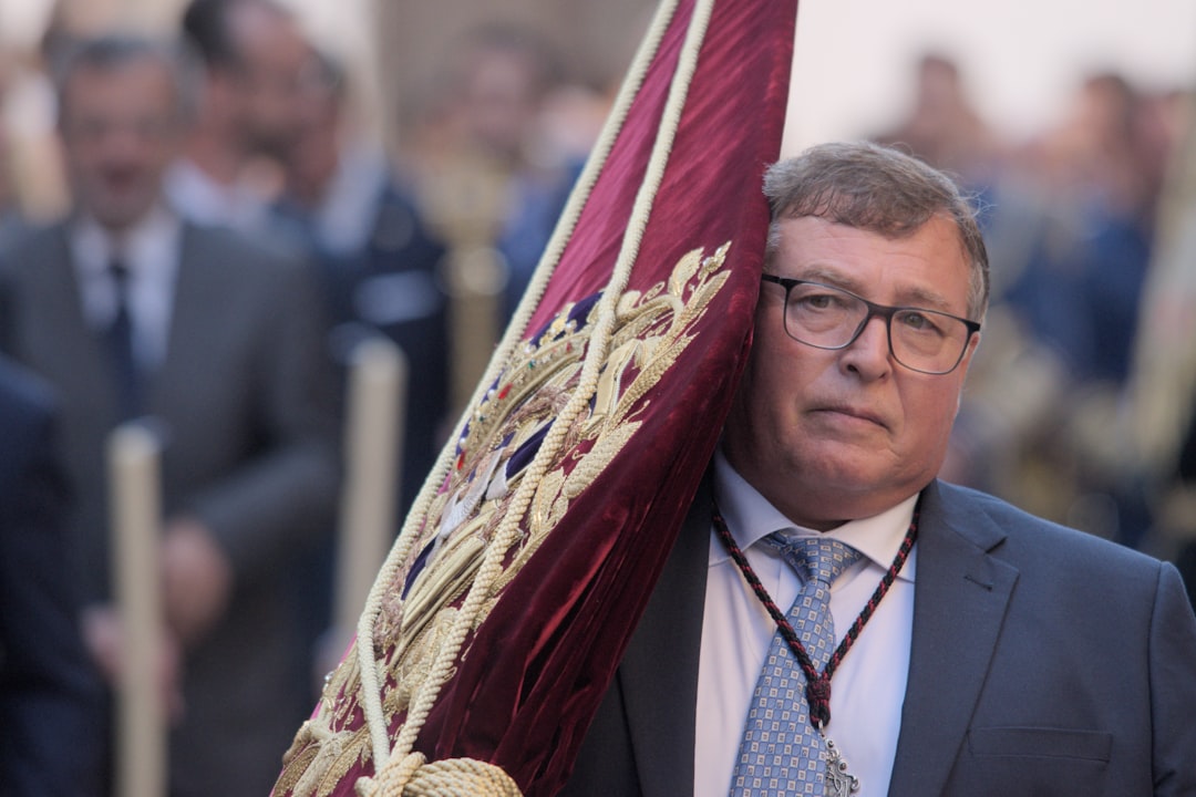 a man in a suit and tie holding a flag
