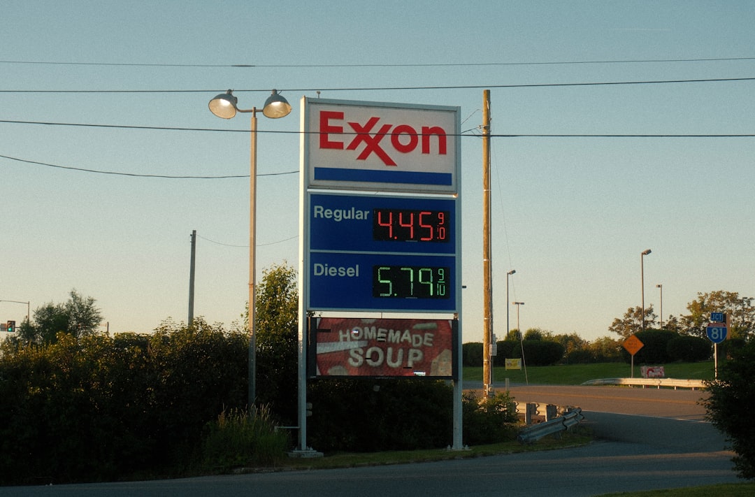 Exxon gas station sign displaying fuel prices and soup advertisement.