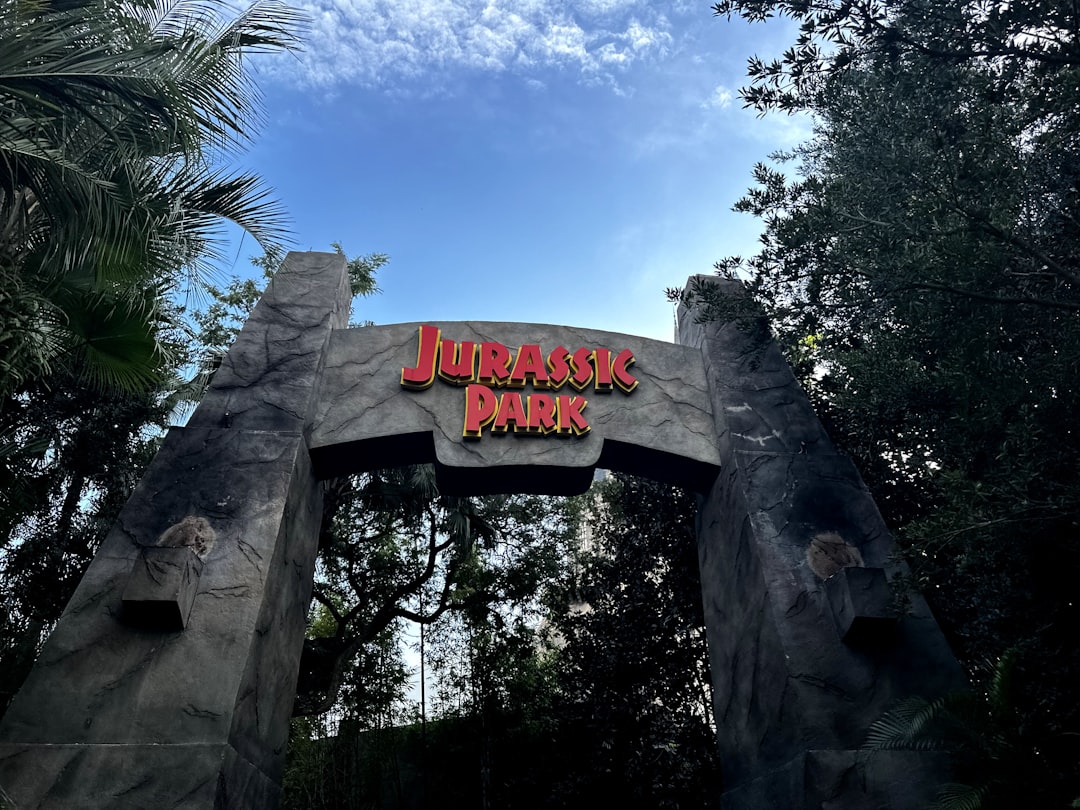 a sign for a park with a sky background
