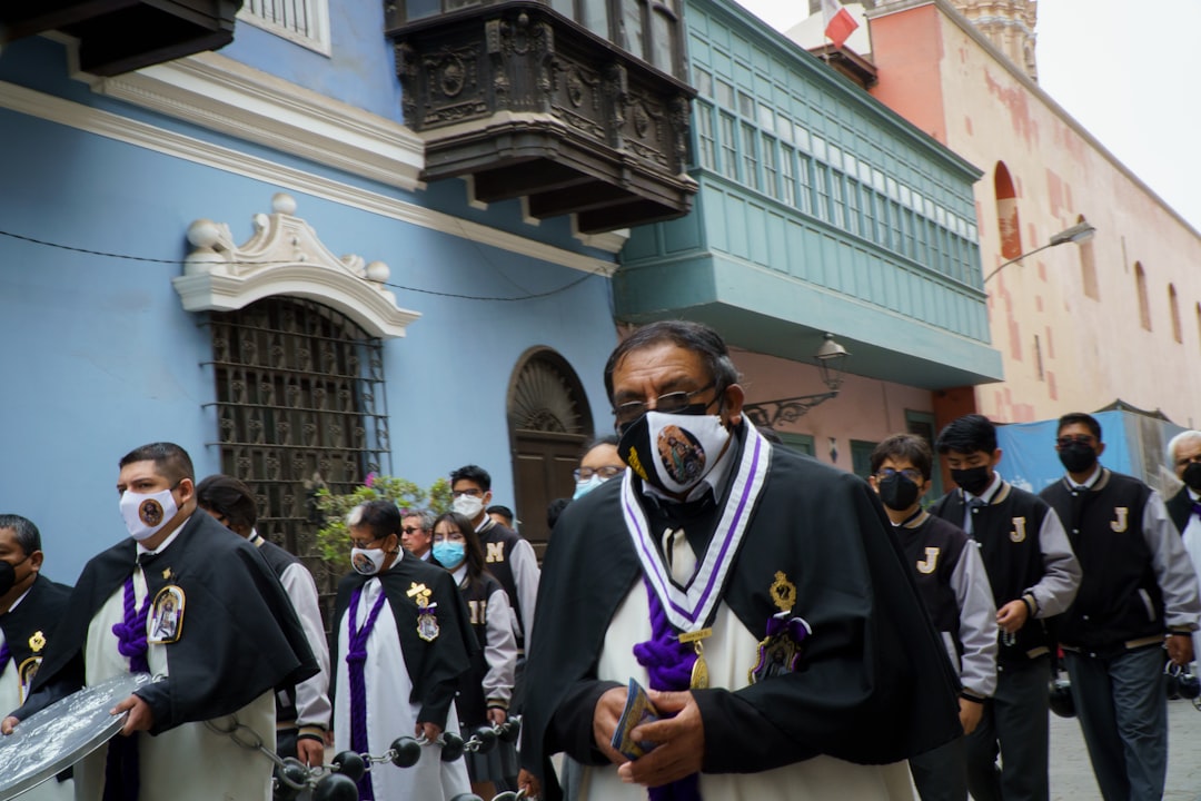 Men in ceremonial robes and masks walking in procession