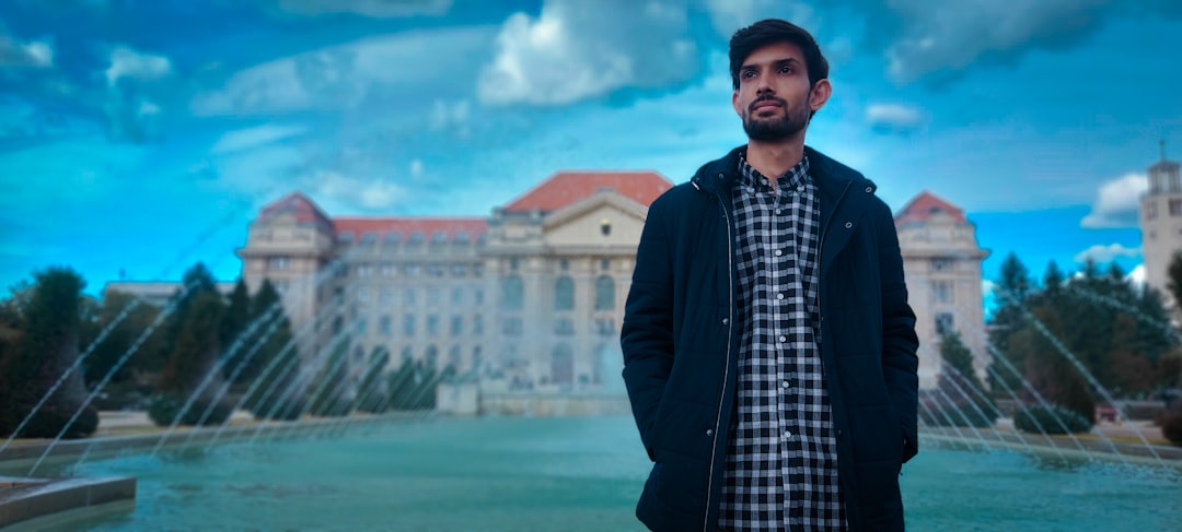 a man standing in front of a fountain