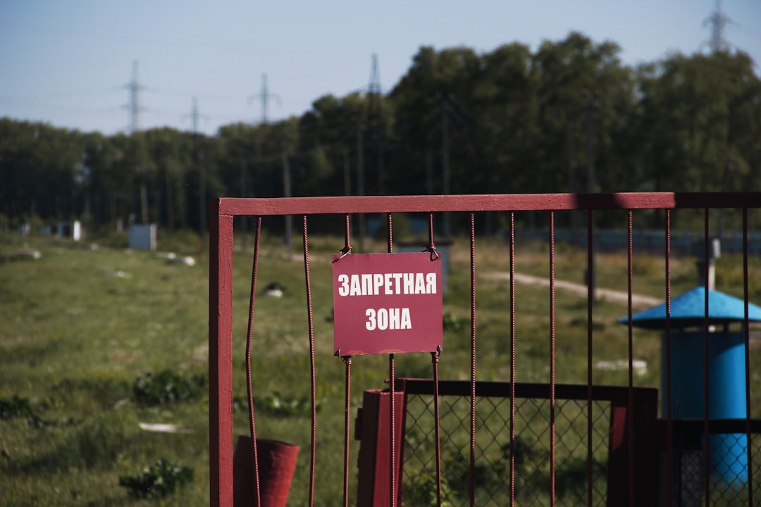 A red gate with a "restricted area" sign.