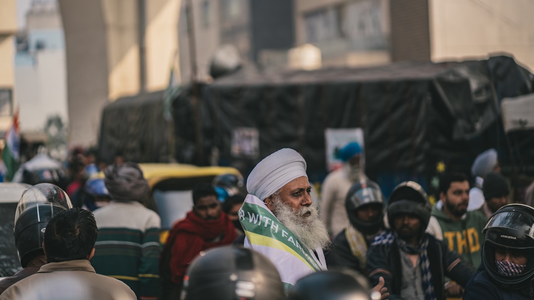 a man in a white turban surrounded by people