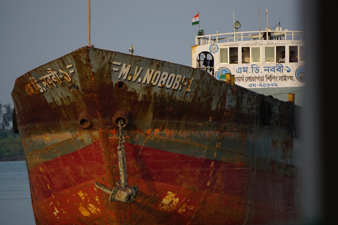 The front of a rusty ship named m.v. norobi.