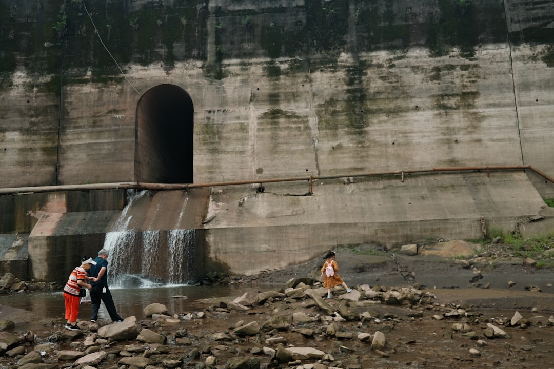a couple of people standing in front of a waterfall