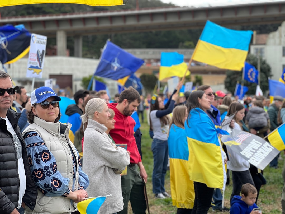 a group of people standing in a field holding flags
