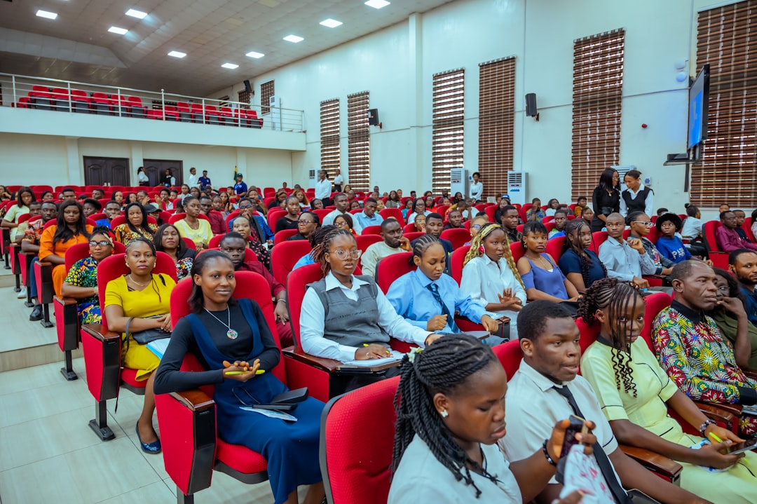 Audience seated in a lecture hall watching a presentation.