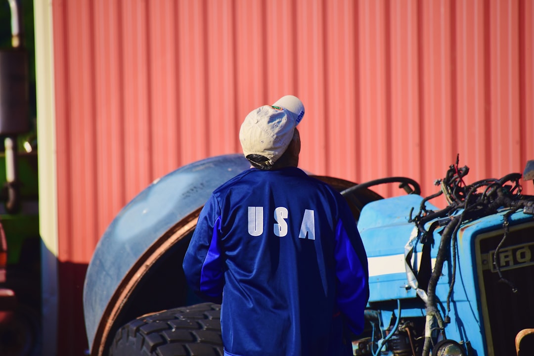 man in blue and black adidas jacket wearing white cap