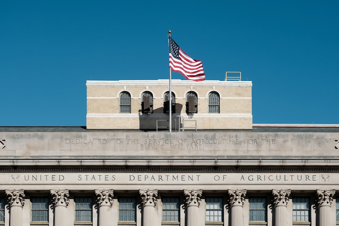 American flag flies over united states department of agriculture building.