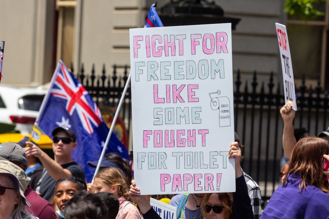 a crowd of people holding signs and flags