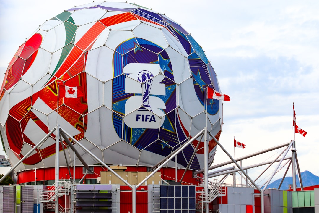 A giant colorful fifa soccer ball structure with canadian flags.