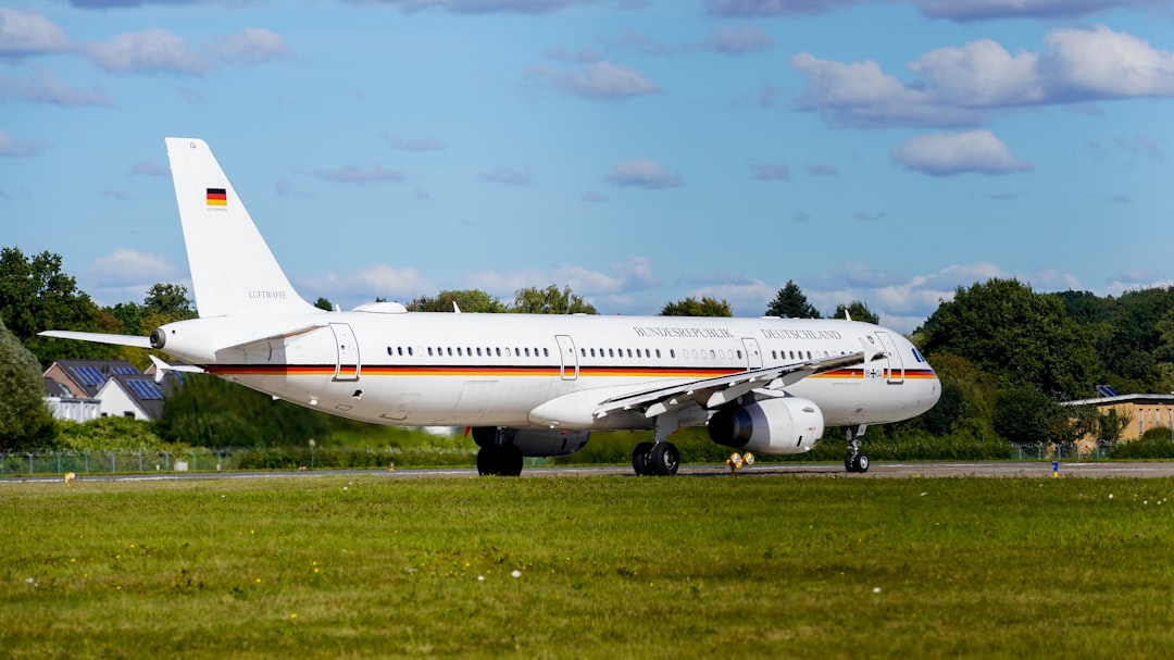 White airplane with german flag on tarmac.