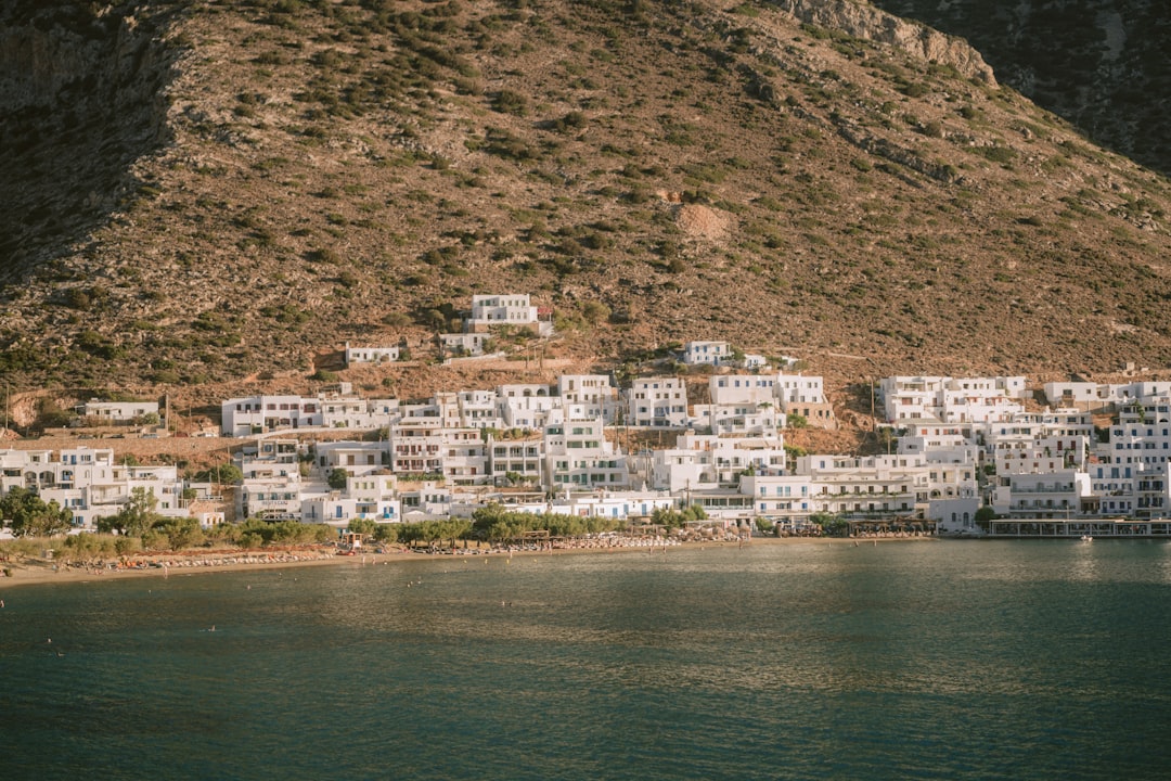 A large body of water next to a mountain