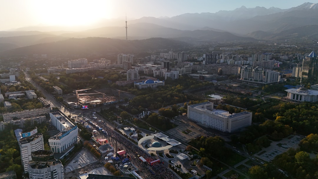Aerial view of a city at sunset with mountains.