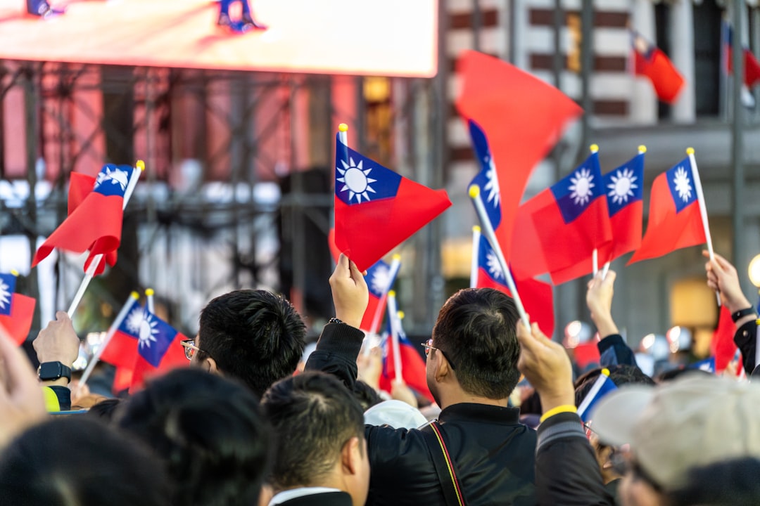 A crowd of people holding up red and blue flags
