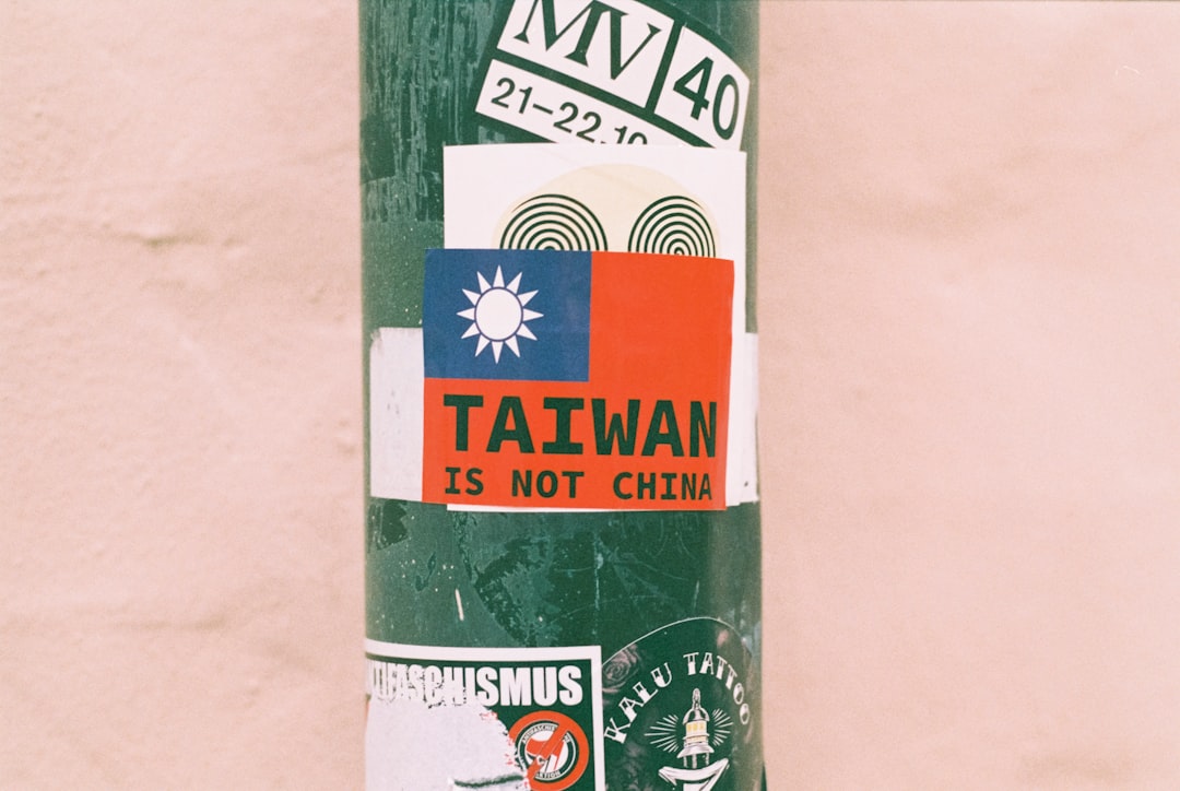 a pole with stickers on it in front of a wall
