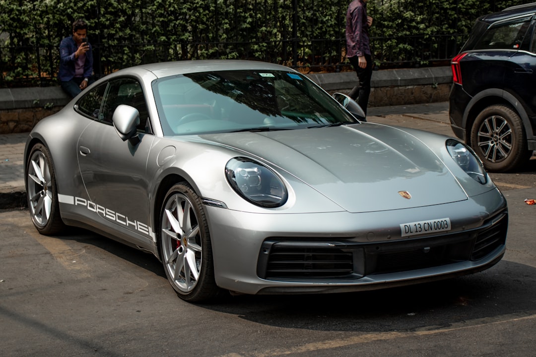 A silver sports car parked in a parking lot