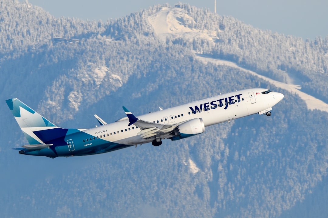 A large passenger jet flying over a mountain range