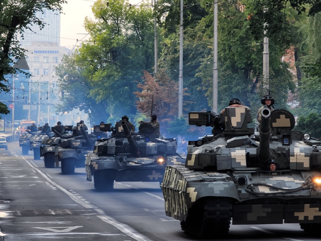 A group of tanks driving down a street