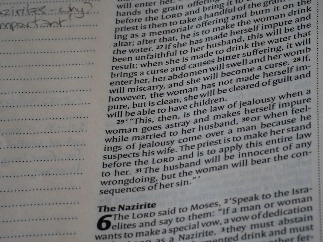Open book showing bible text and handwritten notes