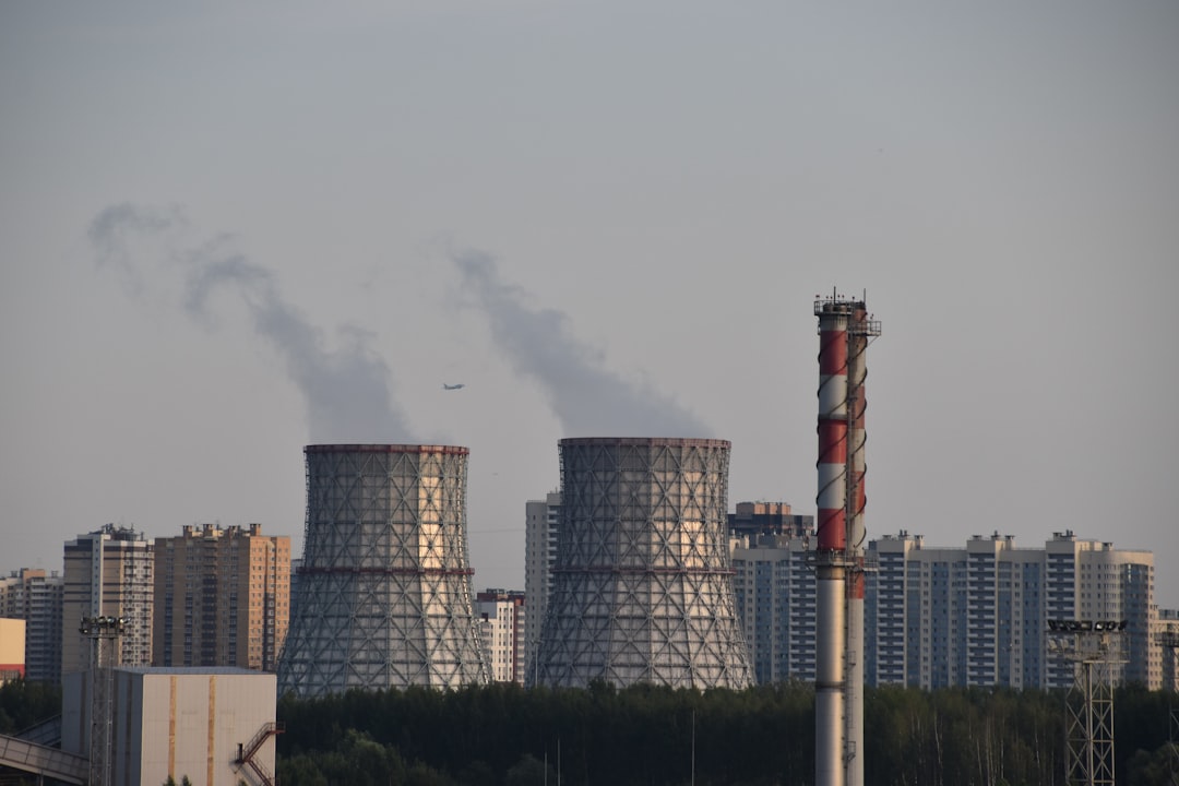 a factory with smoke coming out of it's stacks