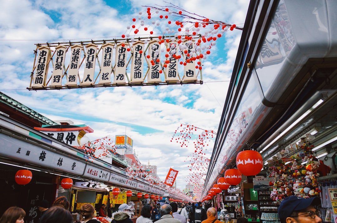 Crowded market street with red lanterns and banners