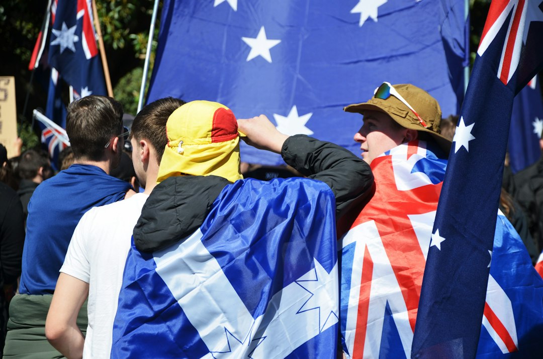 People holding australian flags at a rally