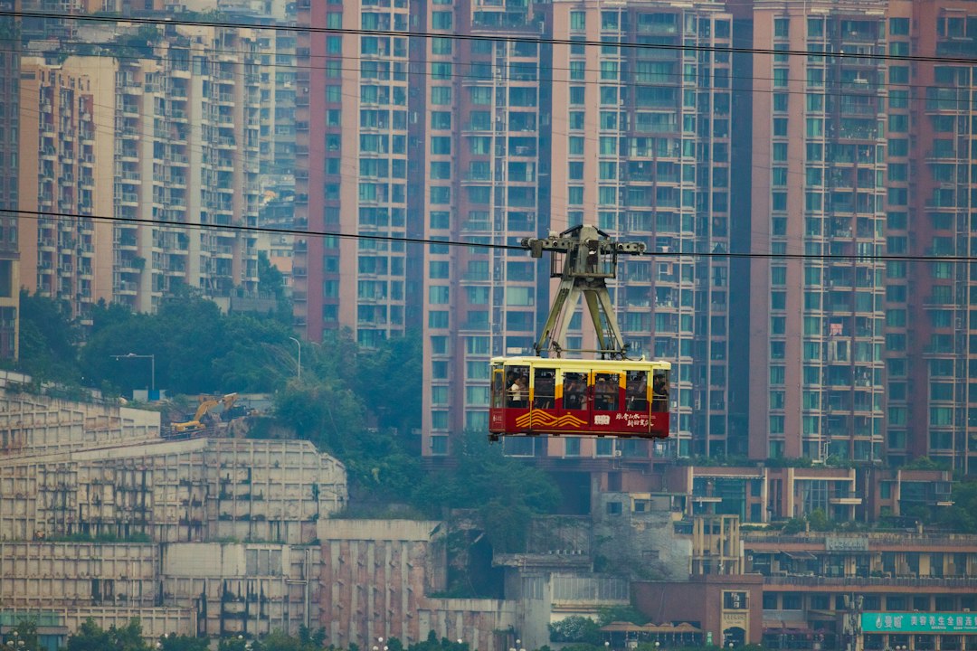 Cable car with passengers against city buildings