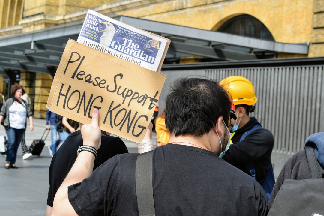 man holding please support HongKong text