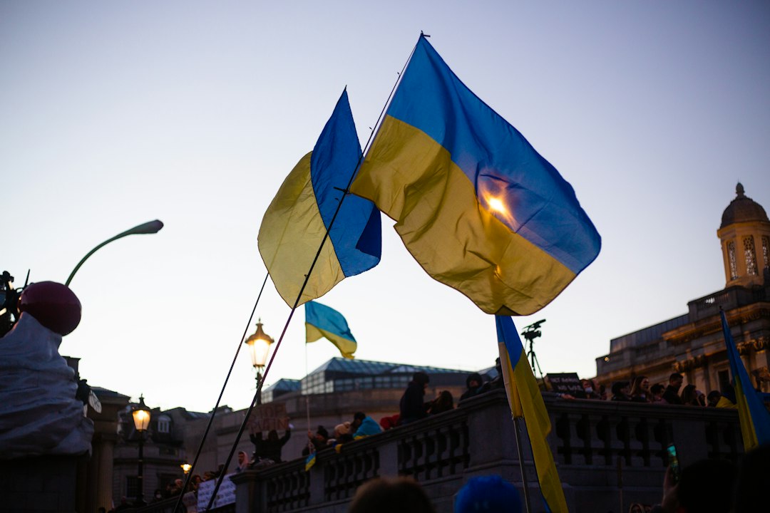 a group of people holding flags in front of a building