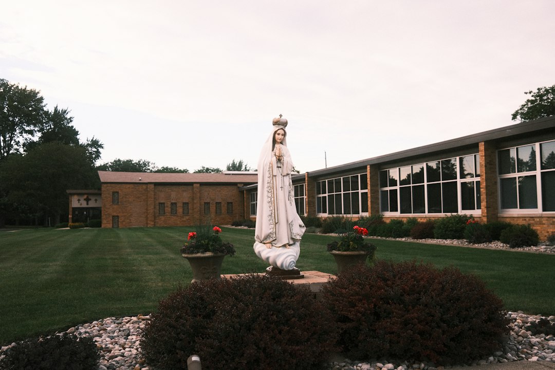 a statue of a woman standing in a garden