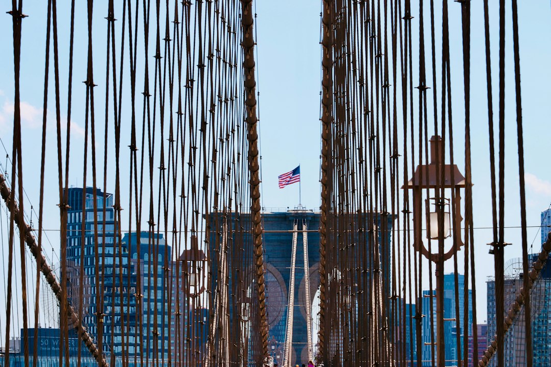 Brooklyn bridge with cityscape and american flag