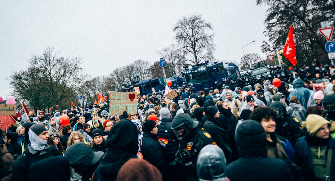 Crowd of people with police in background
