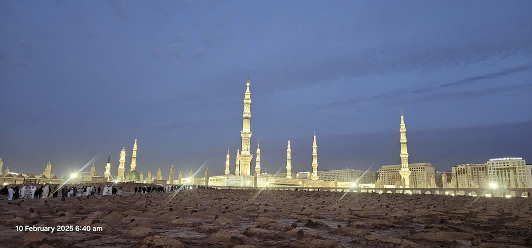 A lit-up mosque at twilight, possibly mecca