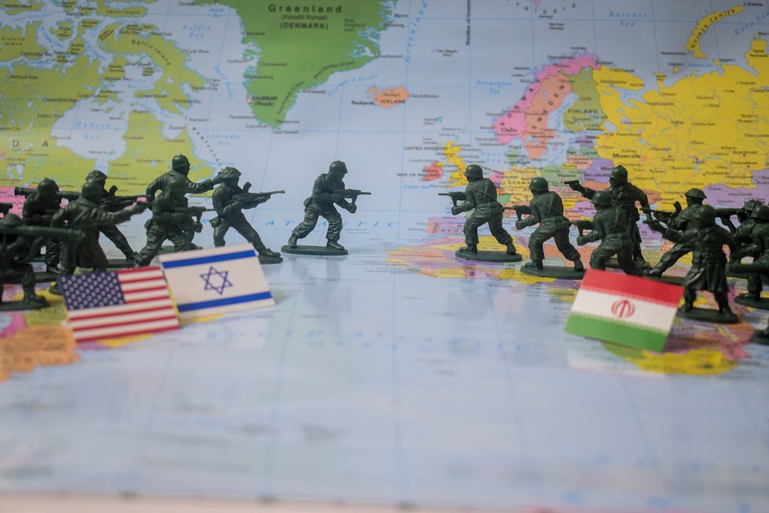 Toy soldiers face off on world map with flags