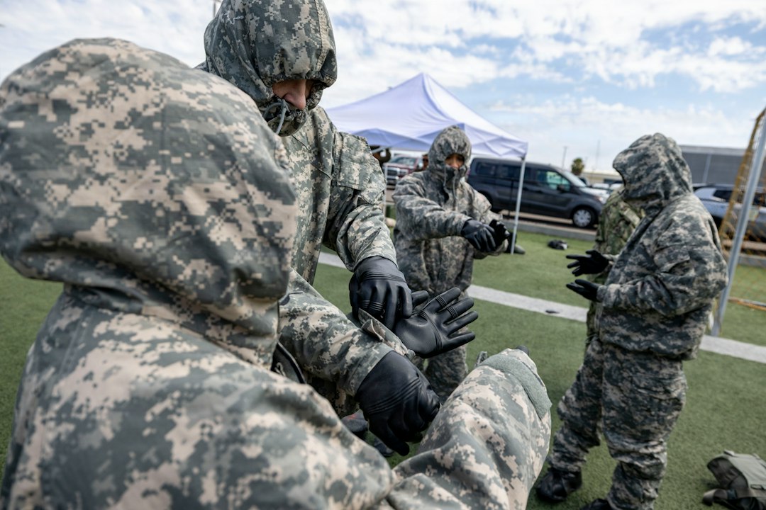 People in camouflage hazmat suits preparing outdoors