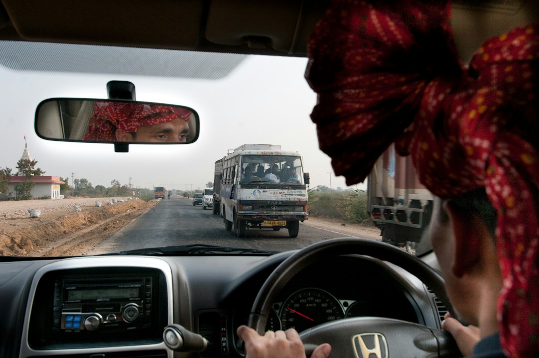 man driving Honda car on road