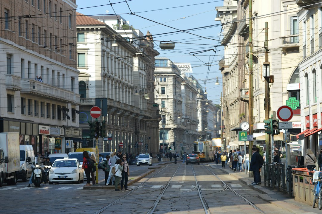 A city street filled with lots of traffic next to tall buildings