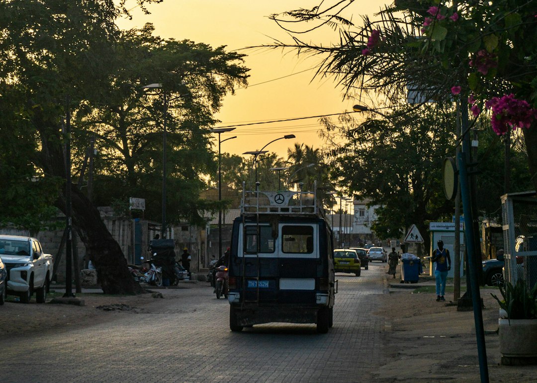 Van driving down a street at sunset